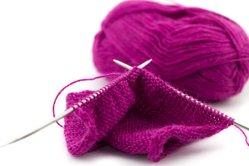Knitting needles with a ball of woolen threads 