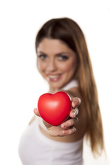 Attractive young woman showing red heart on white backgroung.