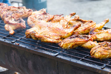 Chicken grilled over a charcoal fire
