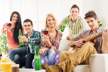 Young People At House Party Toast