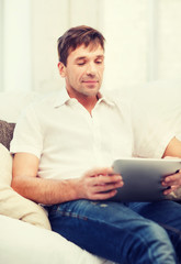 man working with tablet pc at home