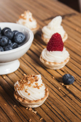 Sweet tartlets filled with cream and , blueberry, raspberry and
