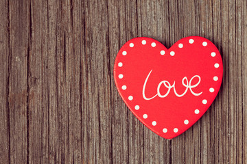 Red valentine's day heart  on retro wooden background with vinta