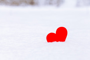 Fototapeta premium Single red heart lying on the snow, romantic love concept