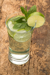 drink decorated with lime and mint leaves
