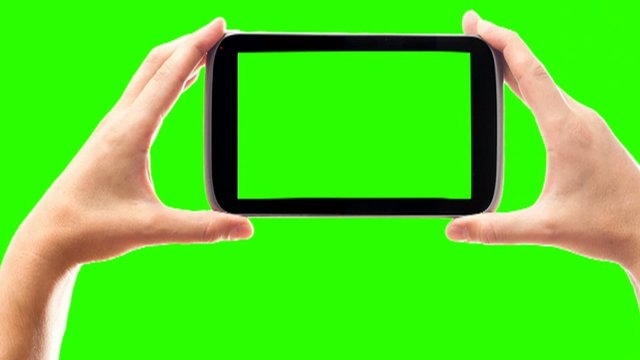hands and phone on a green screen