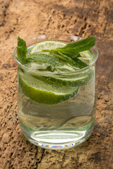 drink decorated with lime and mint leaves