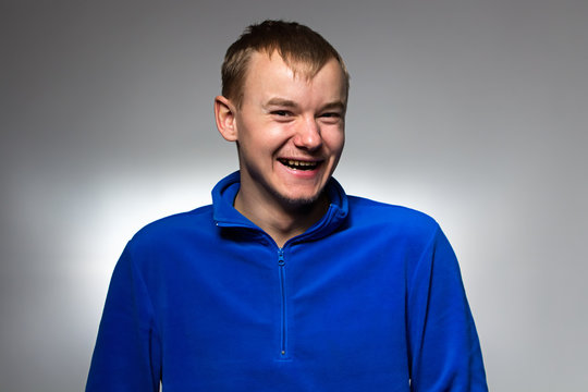 Photo of smiling man in blue pullover