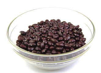 Top view of uncoocked red beans on a cristal bowl. Gernika beans