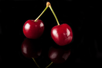 cherry fruit on black with reflection