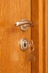 door handle with key in the keyhole and house icon on it