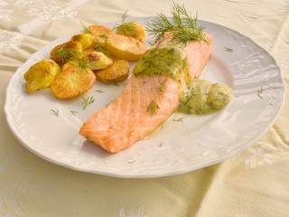 Poached salmon steak with baked potatoes and mustard sauce