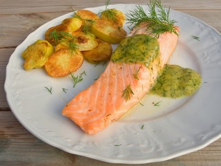 Poached salmon steak with baked potatoes and mustard sauce