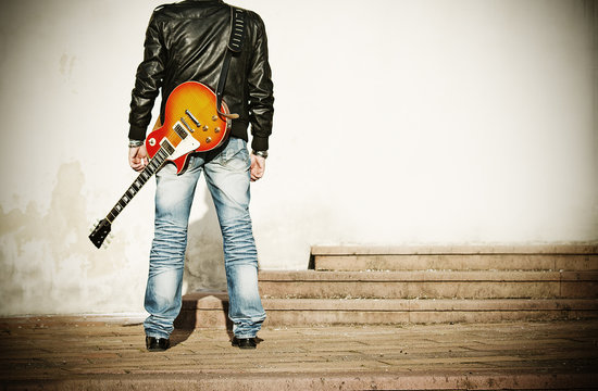 man with a guitar on his shoulder