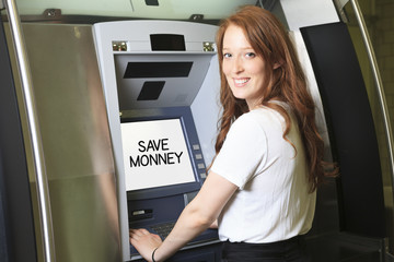Fototapeta na wymiar A student using a ATM machine at school