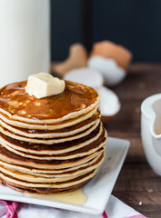Pancake with butter, honey and milk, sweet breakfast
