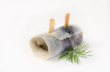 rolled pickled herring with dill on white