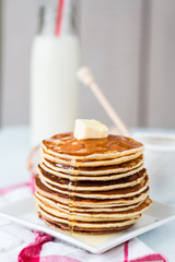 Pancake with butter and honey, a bottle of milk, dessert