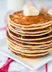 Pancake with butter and honey, a bottle of milk, dessert