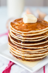 Pancake with butter and honey, a bottle of milk, dessert