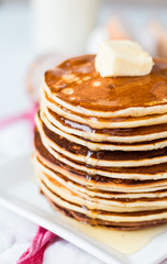 Pancake with butter and honey, a bottle of milk, dessert