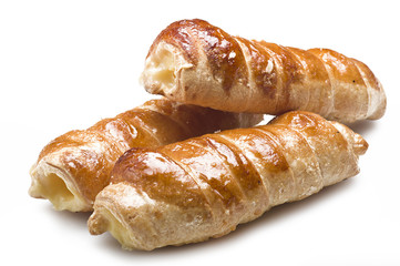 Italian cannoli filled with egg custard on white background