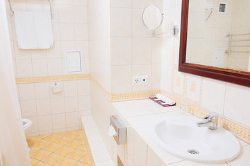 Bathroom cabinet with white sink and large mirror
