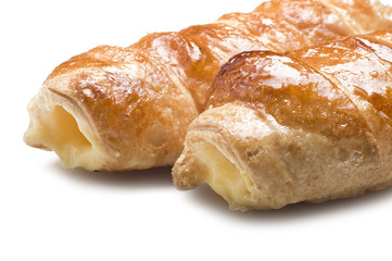 Italian cannoli filled with egg custard on white background