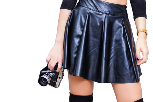 Girl with leather skirt and vintage camera isolated