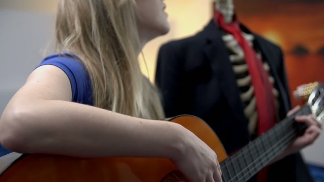 Female plays romantic songs to dead man next to her
