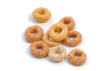 Closeup of a few round breakfast cereals isolated on white