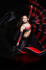 Fototapeta na wymiar Beautiful belly dancer wearing a black costume