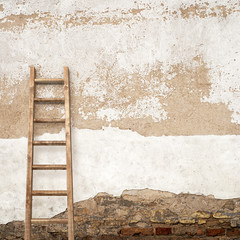 stucco wall with wooden ladder