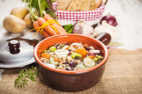 Rural vegetarian broth soup with colorful vegetables and rustic