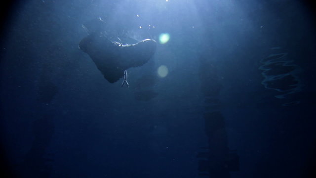 underwater activity and big shoe sinking under water