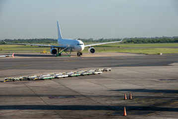Fototapeta na wymiar Aeroplane at airport and Cones on track. Ezeiza, Buenos Aires.