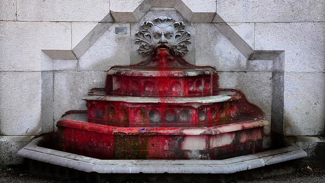 Shot of running blood instead of water in fountain
