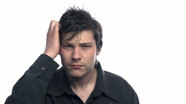 Stressed out man combing hair on white background
