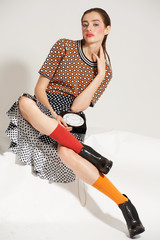 Fashion model pose on light background