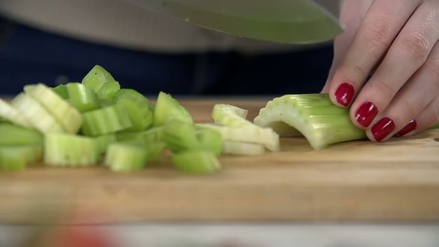 Detail of slicing celery in slices for blending 
