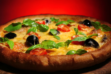 Italian pizza on board and dark colorful background