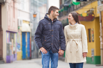 Young Couple walking and holding hands