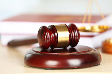 Wooden judges gavel on wooden table, close up
