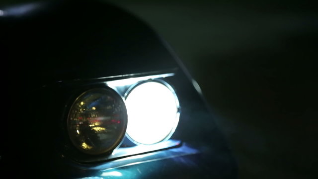 Shallow focus on car lights at nigh time