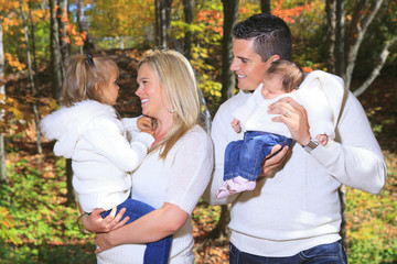 A Family enjoying golden leaves in autumn park