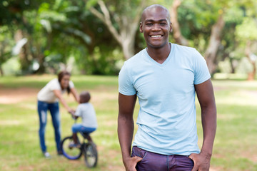 african american man standing in front of family