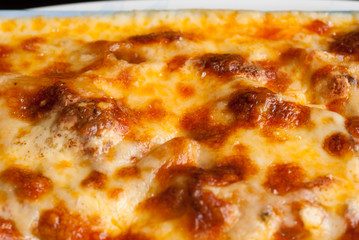 Baked penne pasta with tomato sauce and cheese