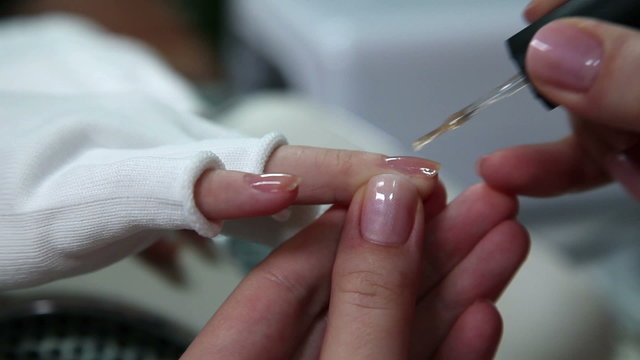 Varnishing nails in a beauty spa