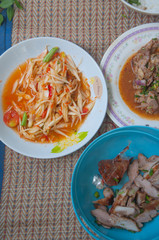 Papaya salad (som tum Thai) with sticky rice , grilled beef and