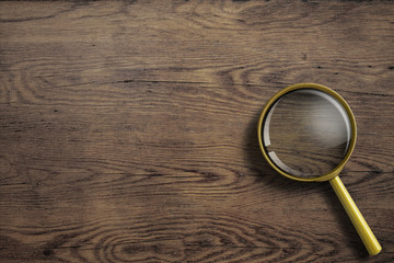 magnifying glass or loupe on wooden table